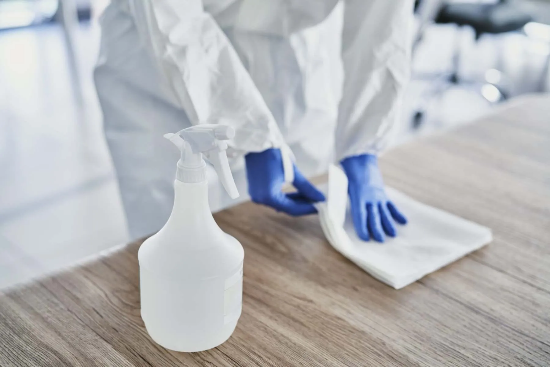 Cleaner disinfecting a work surface, commercial cleaning by John Addley Ltd Liverpool