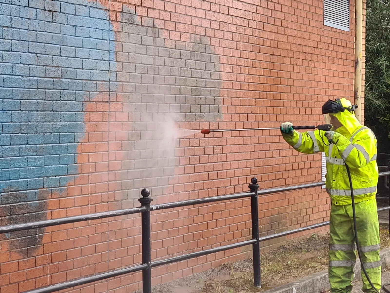Same brick wall after graffiti removal by John Addley Ltd Liverpool