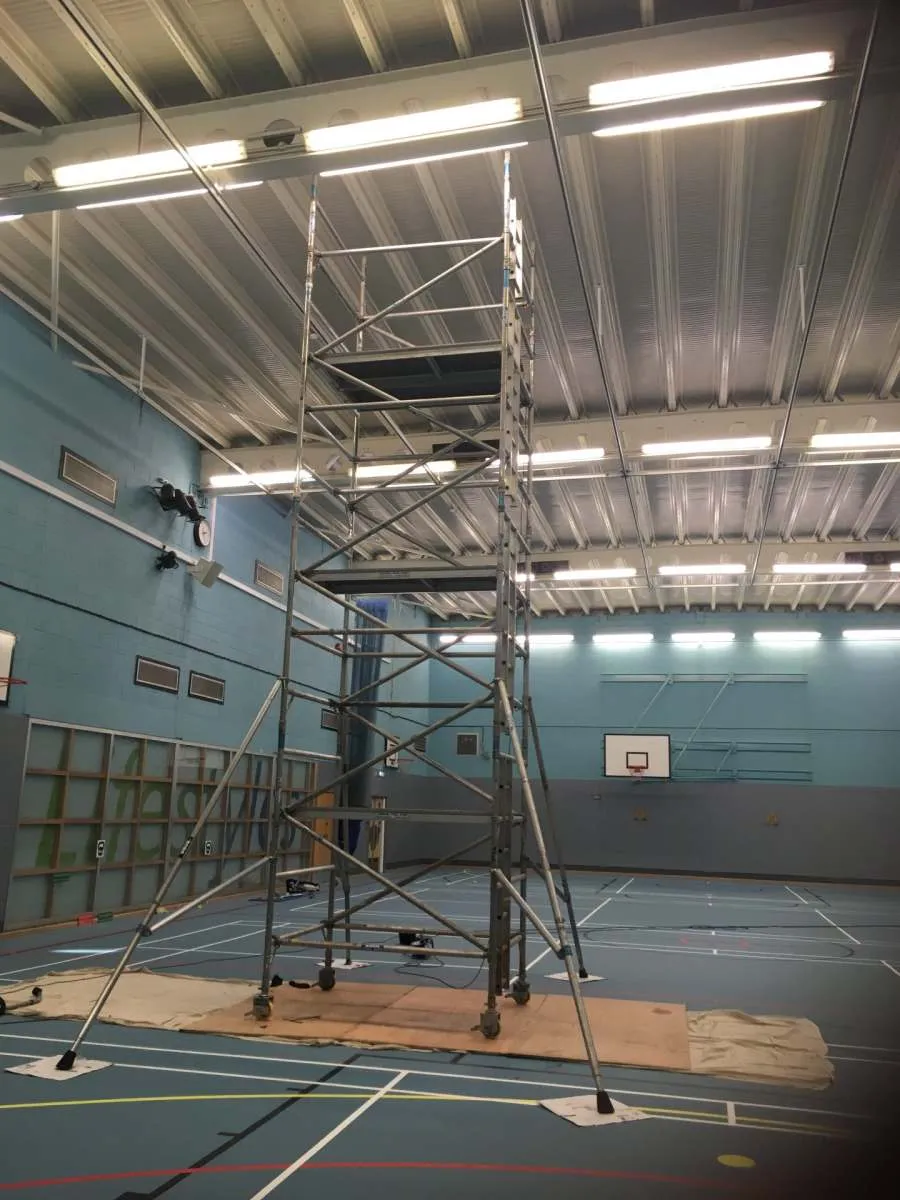 Scaffold tower set up for high level cleaning in a sports hall, John Addley Ltd Liverpool