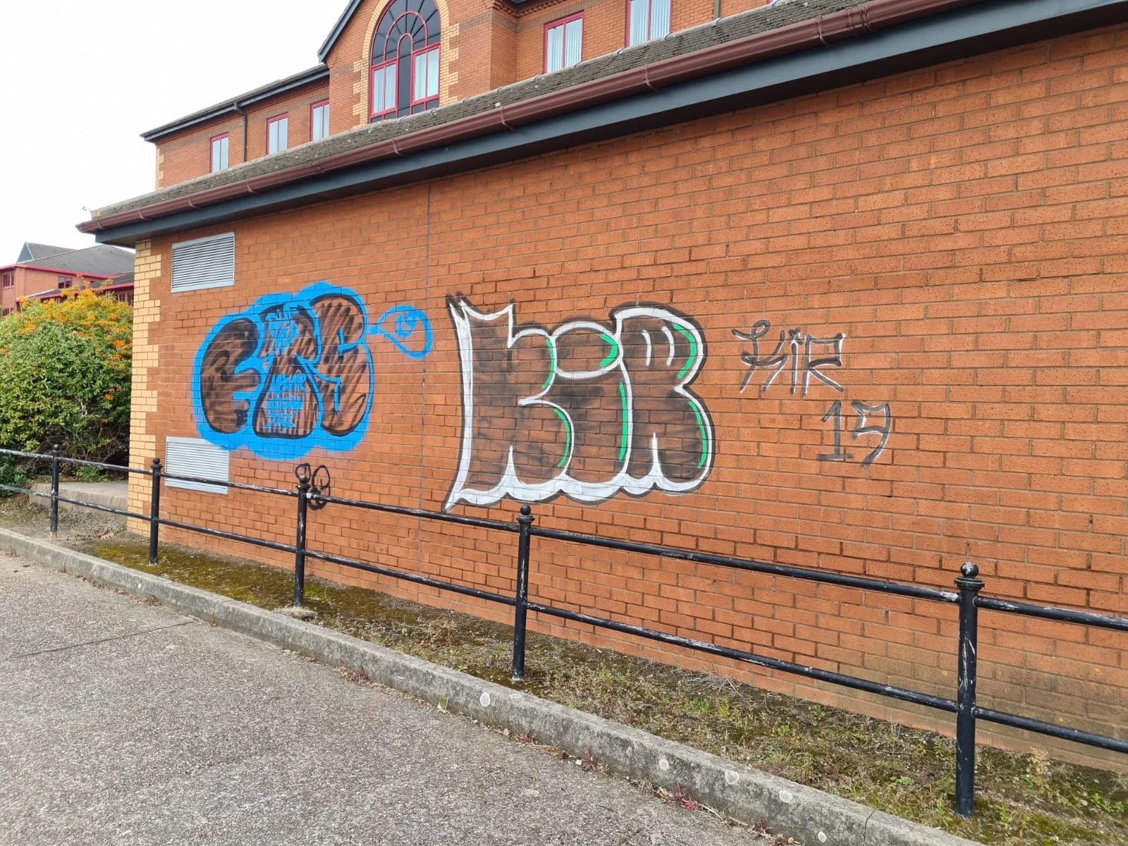 Brick wall covered in graffiti before cleaning, John Addley Ltd Liverpool