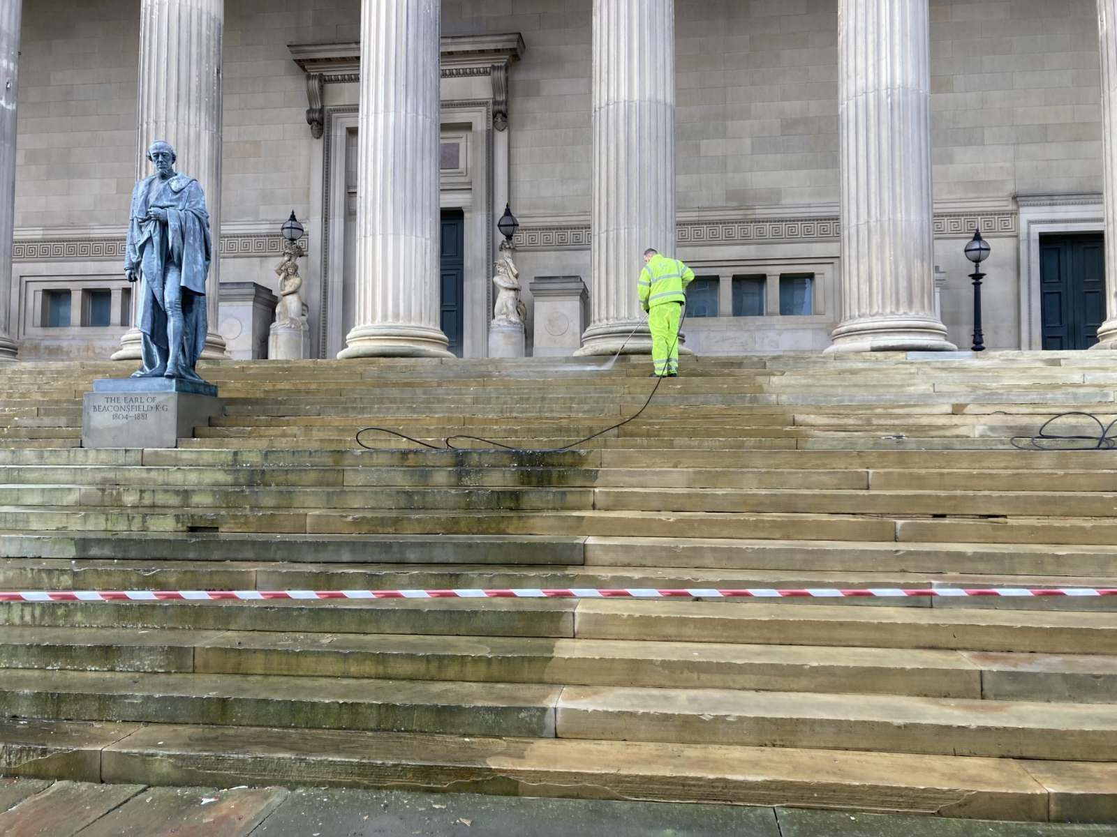Addley operative pressure cleaning the stone steps of a Liverpool civic building, John Addley Ltd